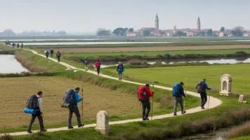 Pellegrini lungo l'antico cammino tra Chioggia e San Basilio con zaini