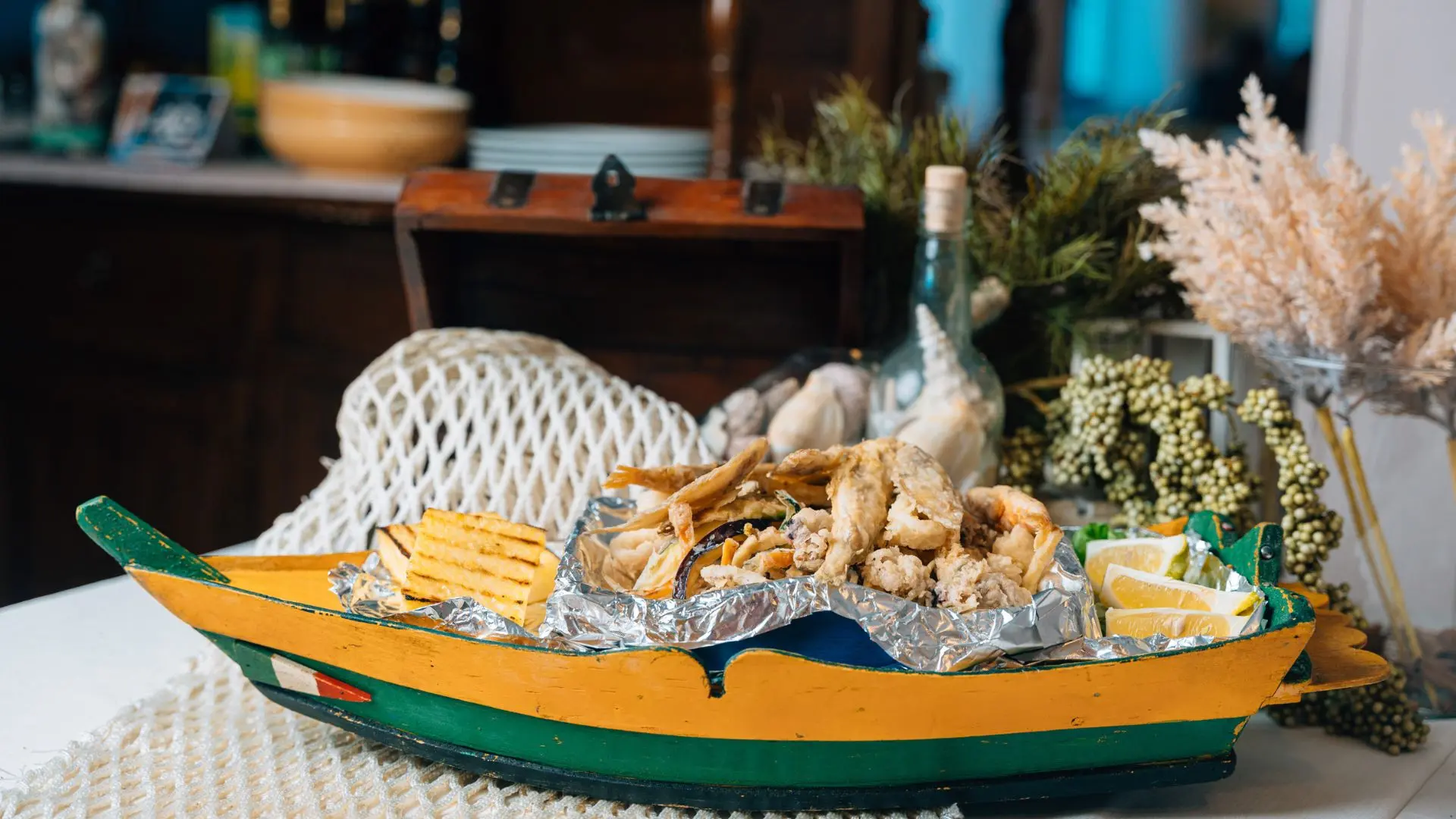 Na Barca de Fritto with fried fish, grilled polenta and lemon on the table at Ponte Molo