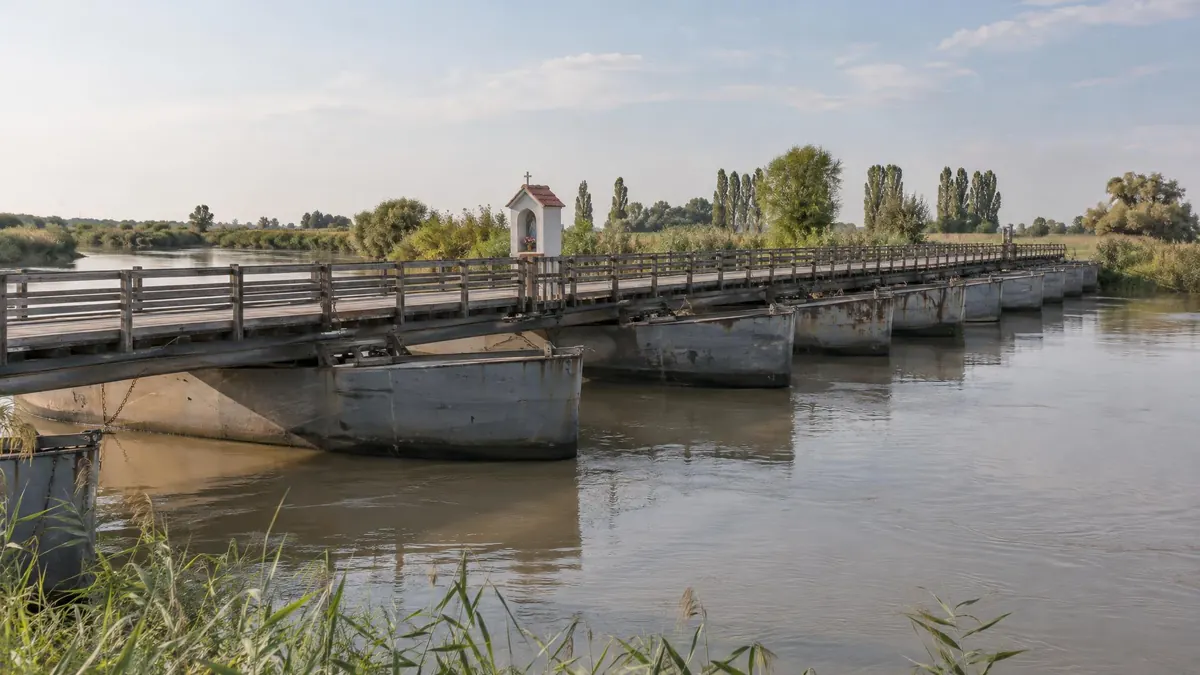 The boat bridge over the Po di Gnocca at Santa Giulia, with the small shrine halfway across